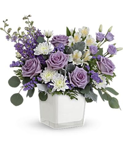 <p data-start="131" data-end="542">Treat someone to a moment of calm, elegance, and luxury with Lavender Blooms—a stunning arrangement that turns any day into a special occasion. With its soft purple tones and graceful silhouette, this bouquet evokes serenity and style in equal measure. Whether you're sending a thoughtful surprise, celebrating a milestone, or simply brightening a space, Lavender Blooms delivers beauty with a whisper of charm.</p>
<p data-start="544" data-end="1044">The bouquet features a soothing blend of lavender roses, airy white alstroemeria, delicate lisianthus, larkspur, and lavender sinuata statice, all accented by white cushion spray chrysanthemums for added fullness and texture. Dusty miller, leatherleaf fern, and silver dollar eucalyptus provide soft greenery that complements the palette while adding structure and balance. Every bloom is hand-selected to ensure freshness and vibrancy, creating a design that feels effortlessly graceful and refined.</p>
<p data-start="1046" data-end="1417">Presented in Teleflora’s Color Splash cube—a modern white glass container with a soft matte finish—this bouquet offers understated sophistication with a versatile look. The cube’s minimalist design makes it easy to reuse as a decorative accent, candle holder, or small vase long after the flowers have faded. It's the perfect pairing of modern style and timeless florals.</p>
<p data-start="1419" data-end="1761">Ideal for birthdays, get well wishes, anniversaries, or even sympathy gestures, Lavender Blooms speaks gently and meaningfully. Its peaceful tones and rich textures make it especially well-suited for creating a sense of comfort, reflection, and appreciation. It’s the kind of gift that says “you’re in my thoughts” without needing many words.</p>
<p data-start="1763" data-end="2067">Each Lavender Blooms arrangement is crafted by hand and personally delivered by a local florist, ensuring a polished and professional presentation. Rosa’s La Hacienda proudly offers this elegant bouquet throughout the Boca Raton area, where every delivery is a reflection of our care and floral artistry.</p>
<p data-start="2069" data-end="2171" data-is-last-node="" data-is-only-node="">Surprise someone with the soft beauty of Lavender Blooms—an arrangement as calming as it is luxurious.</p>
